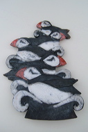 puffins riding the crest of a wave